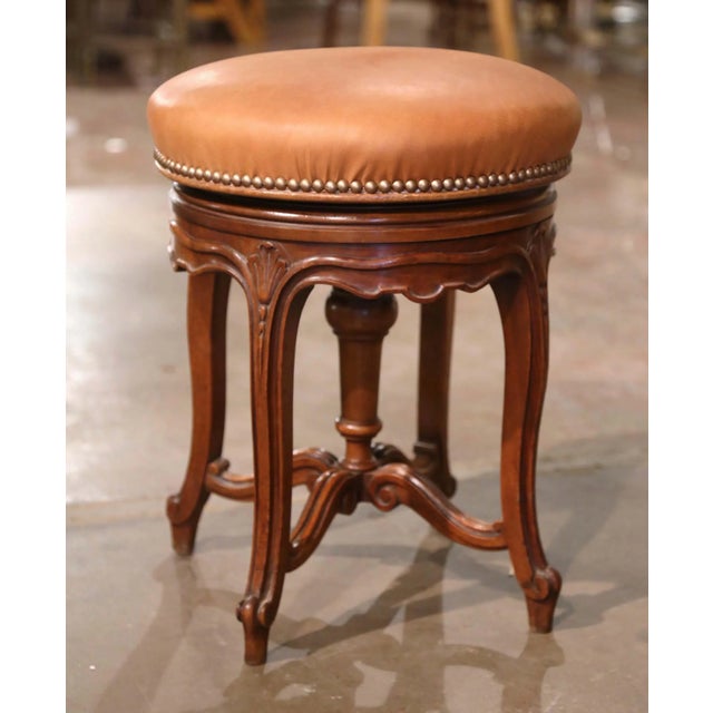 Elegant and practical, this antique piano stool offers graceful Louis XV styling and an adjustable seat. Crafted in...