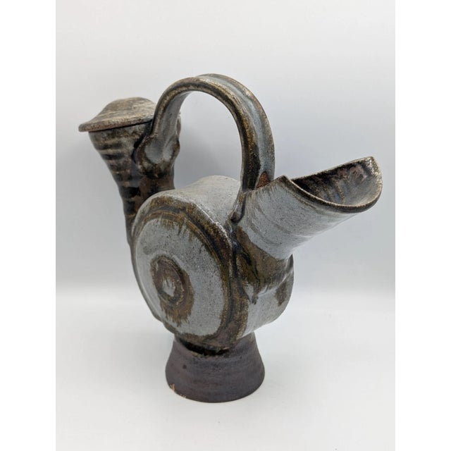 This Vintage Mid Century Modern Ceramic Studio Art Pitcher with Lid is a unique and handmade piece of art pottery from the...
