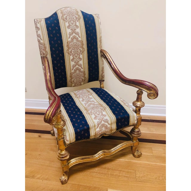 This chair is very large and fit for a king. Gold gilt arms and legs, fabulously elaborate fabric. Purchased in the 1980...