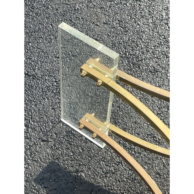 Iconic mcm design by Charles Hollis Jones. A base consisting of brass stretchers attached to rectangular Lucite blocks....