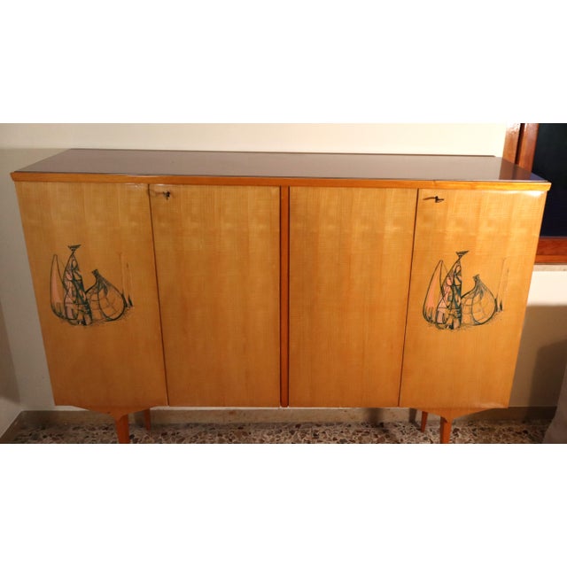 A beautiful piece of furniture designed and crafted in the mature style of Vittorio Dassi, with compass legs in beautiful...