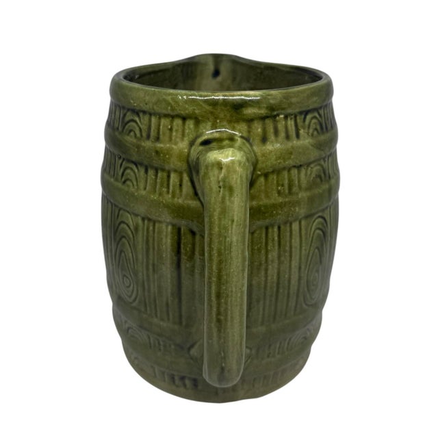 This vintage stoneware pitcher is a must-have for any collector of retro kitchenware. With a bright green color and a...