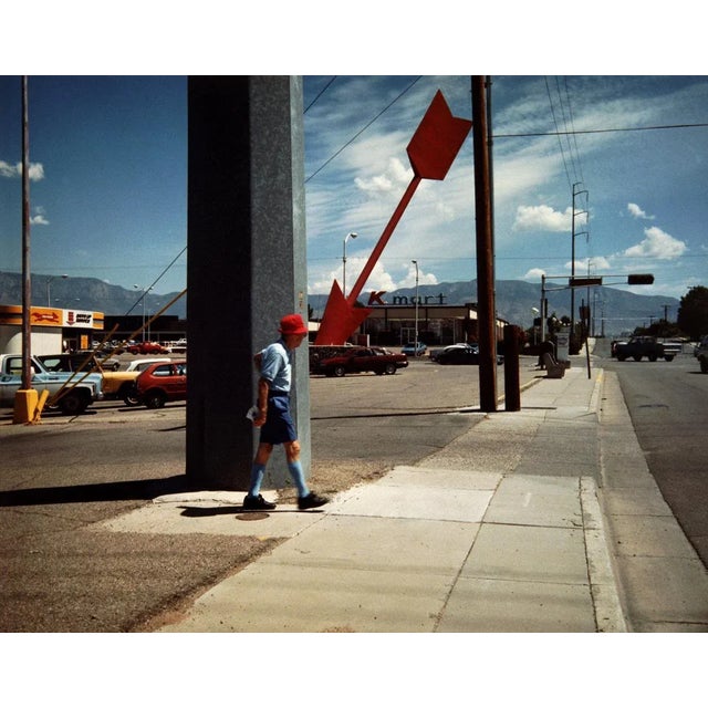 Man and Red Arrow, Albuquerque, New Mexico is a stunning Colour Print on Hahnemuhle Paper available in this size of 20" x...