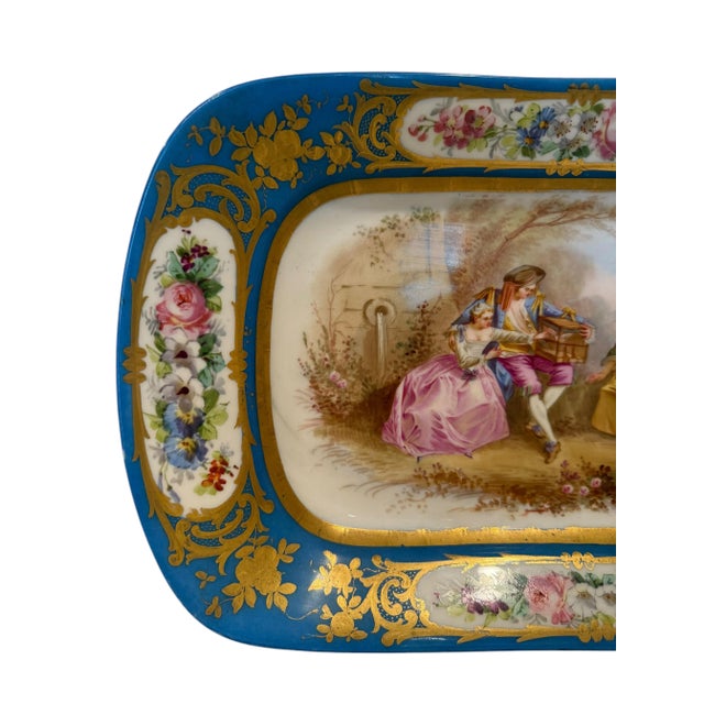 A Sevres style decorative plate dating back to the 19th Century. It features a hand-painted pastoral scene in the center,...