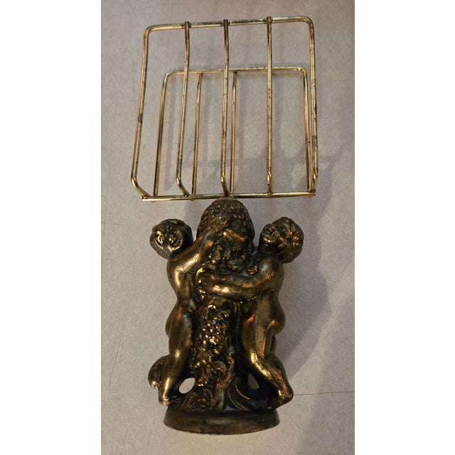 Vintage Mid Century Hollywood Regency Cherub Angel Brass Towel Holder. 10 inches tall 4.5 inches wide 2.5 inches deep