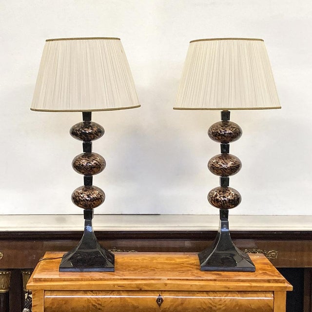 A pair of elegant Venetian table lamps from the 1960s, featuring a Murano glass stem and a 46 cm diameter lampshade....