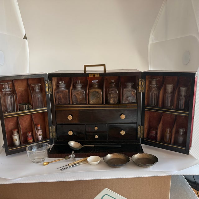 Offering this authentic late 19th century Victorian traveling apothecary medical cabinet crafted from fine Mahogany with...
