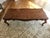 A vintage French Provincial style coffe table with a scalloped-edge, stunning parquetry tabletop and cabriole legs. The...