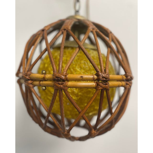 This fascinating bamboo and rattan pendant light has little brass hooks on either side that open the pendant, so you can...