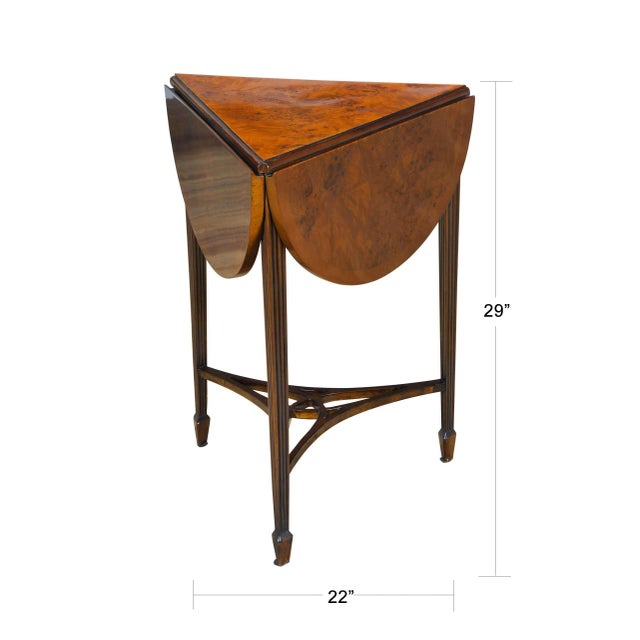 This three leg or tripod Burled Handkerchief Table closes to small triangular size when the leaves are not in use and...