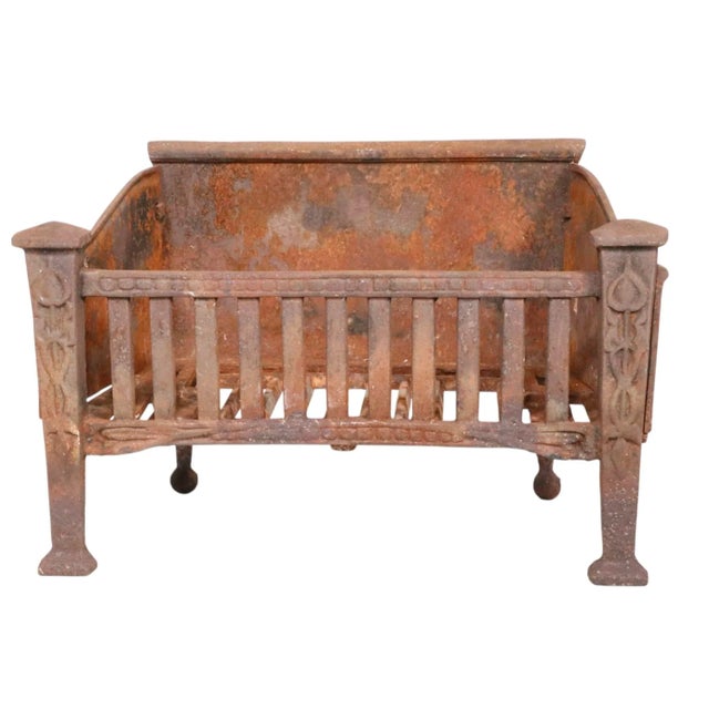 Cast iron fireplace insert coal grate, from the Arts and Crafts period. The grate features stylized cast iron decorative...