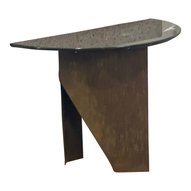 A striking contemporary sculptural console table handcrafted from chemically patinated Corten steel with a polished black...