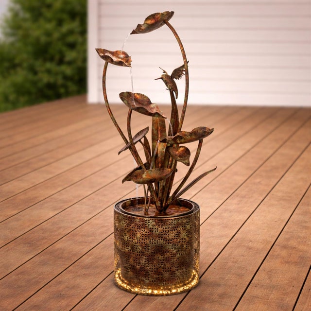 Add a touch of natures beauty to your space with the Cascading Iron Hummingbird and Leaf Fountain. Featuring earthy brown...