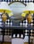 An oversized round wall mirror featuring a black lacquer frame with hand-painted gold scenic decoration inspired by...