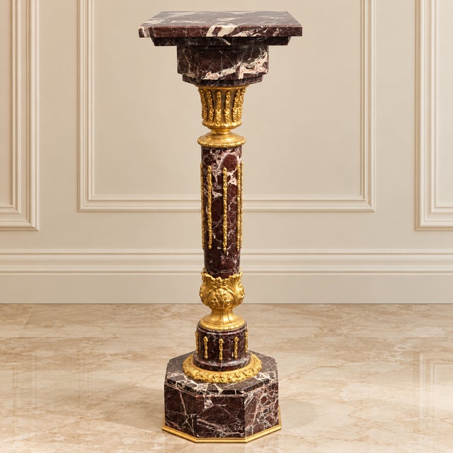 Elevate a room with this striking French-inspired neoclassical pedestal, featuring rich brown and black marble tones...