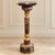 Elevate a room with this striking French-inspired neoclassical pedestal, featuring rich brown and black marble tones...