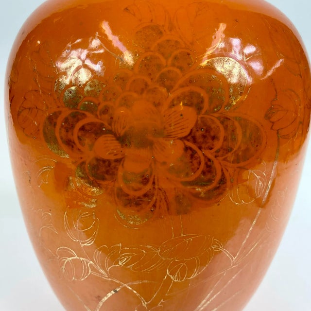 A rather tall and large porcelain orange vase from late 19th century China. This is gold gilt with a large chrysanthemum...