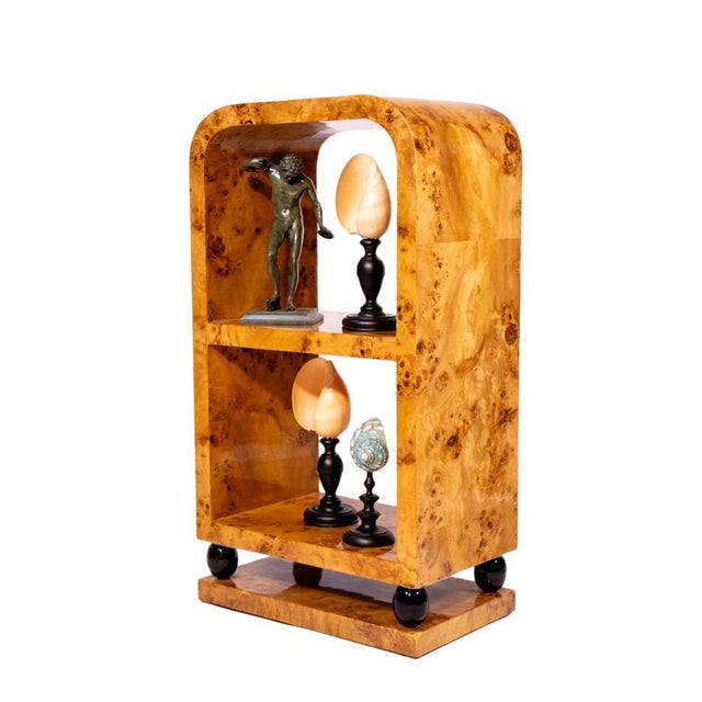 A striking Art Deco side table or étagère, entirely veneered in richly figured burl walnut with a warm amber high-gloss...