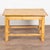 Rustic 20th century short side table, crafted in pine. The table stands on four square legs joined by a simple trestle...