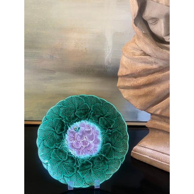 English majolica wall plate covered with leaves and a begonia flower in the center, made in the 1880's.