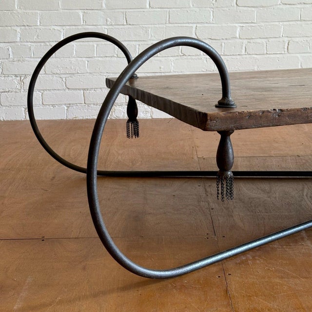 A quite extraordinary & sizeable monolithic hardwood coffee table with handcrafted blacksmith made iron frame suspending a...