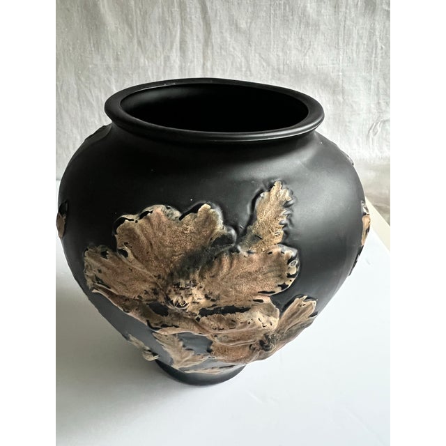 An elegant 1930s vase by the Tiffin Glass Company, crafted in black satin glass that reveals a deep amethyst undertone...