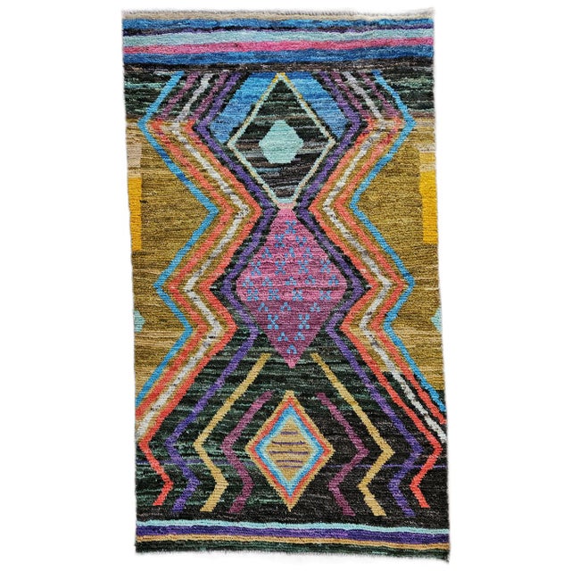 An authentic hand-knotted Afghan tribal rug, an expression of the nomadic textile tradition of western Afghanistan. This...