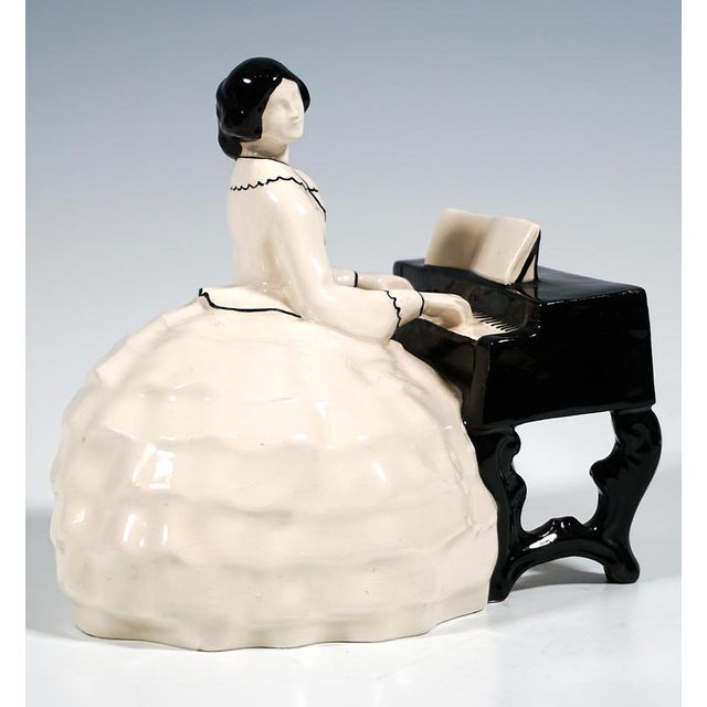 Excellent and rare art nouveau ceramic piece from the early 20th century: a lady in a crinoline with her hair pinned up...