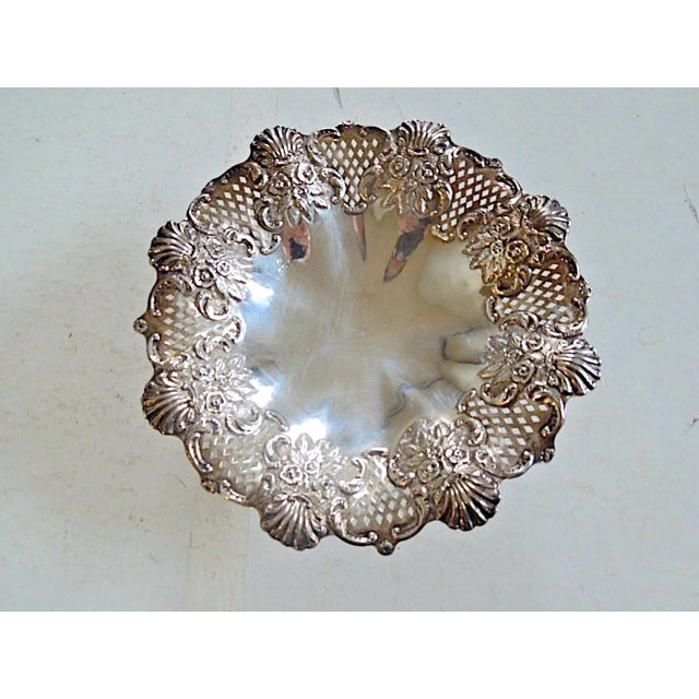 Offered is an exquisite reticulated sterling silver compote featuring repousse floral bouquets around the rim. Made in...
