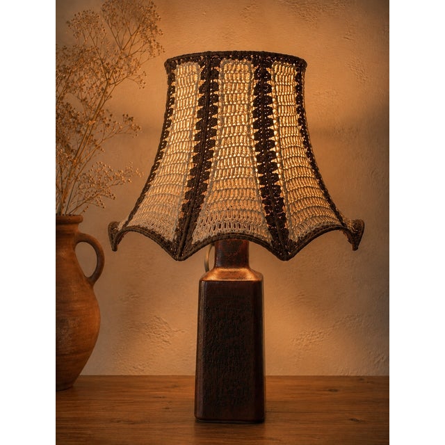 An extraordinary and highly collectible danish table lamp by désirée stentøj, combining a thule-series stoneware base with...