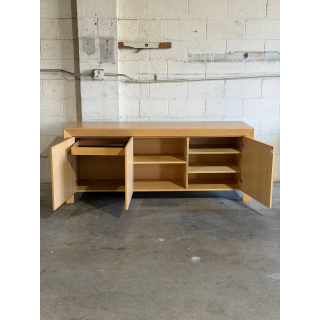 This 3-door credenza features a minimalist profile defined by clean lines and flush panels. The streamlined silhouette is...