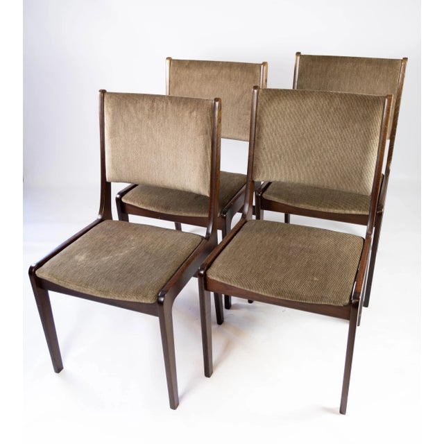 Set of four dining room chairs in dark wood and dark fabric of Danish design manufactured by Farstrup in the 1960s. The...