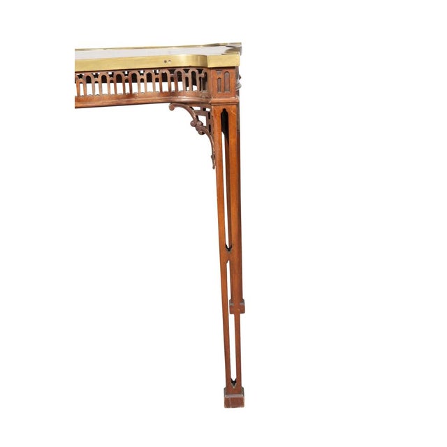 George III Mahogany Table shaped rectangular top with brass bound edge with conforming fret carved frieze. Tapered square...