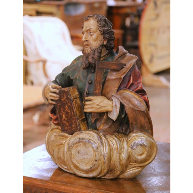 This expressive antique polychrome carved wood sculpture depicts Saint Thomas the Apostle, identifiable by the carpenter’s...