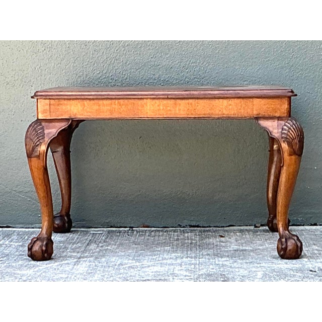 This elegant vintage coffee table is a sophisticated tribute to 18th-century Chippendale design, blending classical...