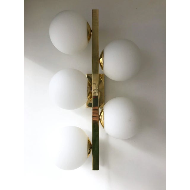 Contemporary gilt brass wall lights sconces, blown Murano opaline tick glass ball. Few exclusive artisanal production. In...