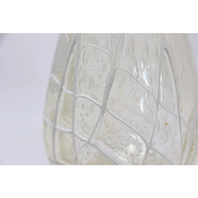 A stunning example of Murano craftsmanship, this beautiful transparent glass vase hails from Murano, Italy, and dates back...