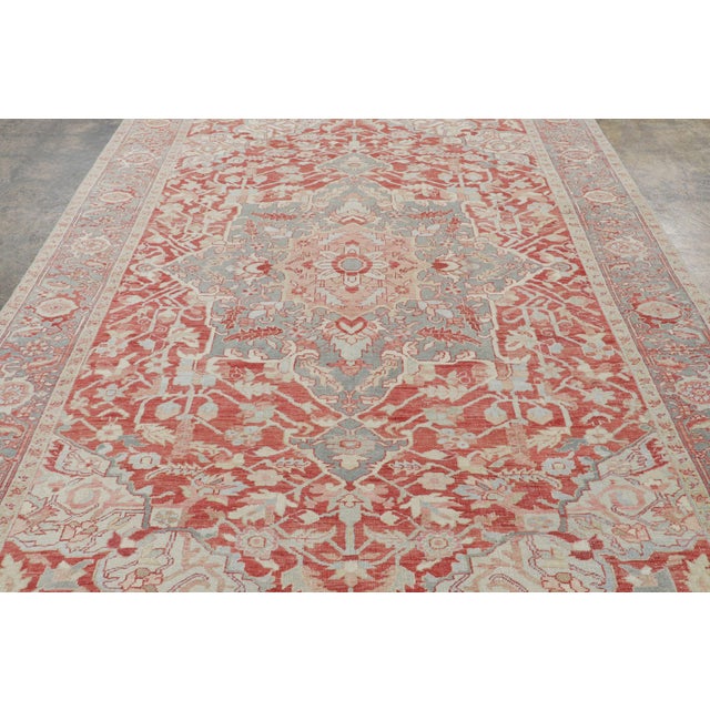 Hand-knotted in wool, circa 1920-1940, this 7x9 antique Heriz rug is a compelling example of the region’s renowned...
