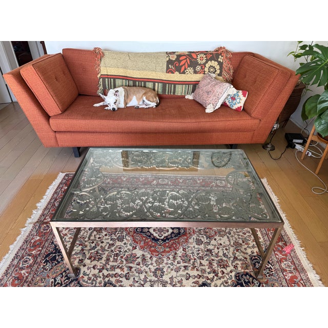 Heavy vintage wrought iron coffee table featuring an intricate grapevine and leaf motif with a thick glass top. Rich dark...