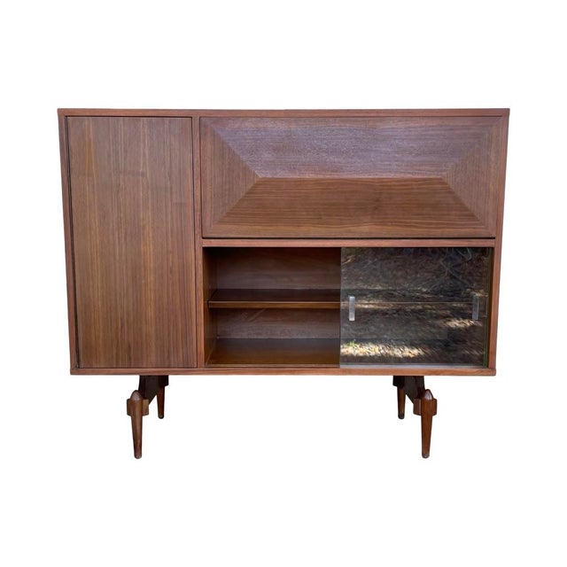 Stunning Italian inspired Midcentury dry bar with Diamond front drop-down lighted bar, circa 1950s. The exterior has been...