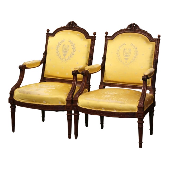 Pair of 19th Century French Louis XVI Walnut Fauteuils With Eagle Crest For Sale