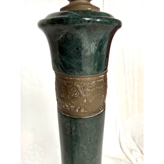 A tall brass floor lamp made by Frederick Cooper. Asian Regency. There are bands of engraved scenes around each node with...