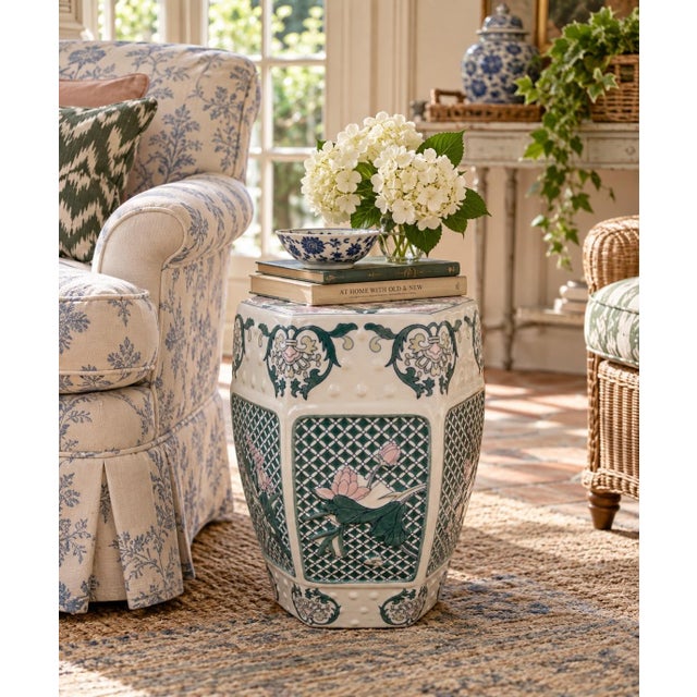 A classic Chinoiserie blue, white, pink, and green porcelain garden stool, plant stand, or small side table decorated with...