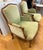 Pair of elegant French bergère armchairs featuring gracefully carved wood frames and classic cabriole legs. Upholstered in...
