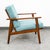 Mid century modern arm chair in solid wood and upholstered in a aqua blue fabric. Wood arms on either side. outstanding...
