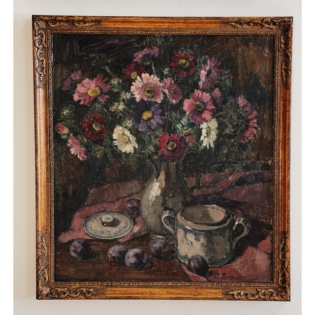 A signed Belgian still life depicting a generous bouquet of garden blooms—dahlias and daisy-like flowers in deep rose,...