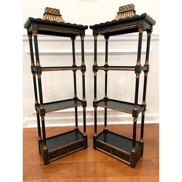Ebonized three tier wood wall etagere or curio. Gilded foliate detailing. Pagoda style pediment. Drawer in bottom with...