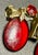 Set molded ruby red translucent lucite cameos in antique gold-tone setting with Victorian silhouette and side-mounted...