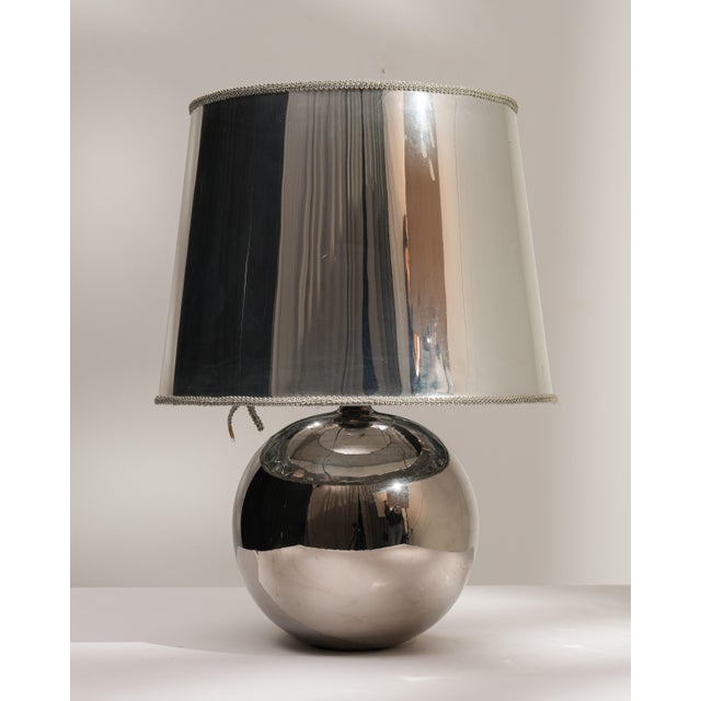 A sleek glass table lamp showcasing clean lines and a minimalist aesthetic. The transparent or lightly tinted glass body...
