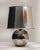 A sleek glass table lamp showcasing clean lines and a minimalist aesthetic. The transparent or lightly tinted glass body...